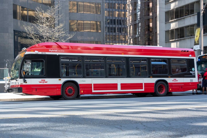A TTC hybrid electric bus is seen waiting on University Avenue in Toronto on May 24, 2020.