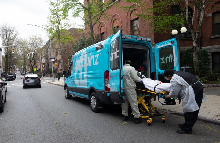 Ambulance workers pick up an elderly man in March 2020 from Cobble Hill Health Center, one of the nursing homes in New York C