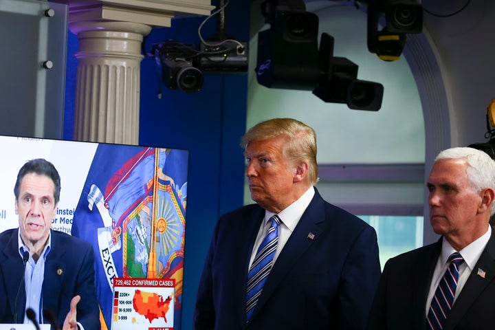 President Donald Trump, with Vice President Mike Pence, watches a clip of New York Gov. Andrew Cuomo at the daily coronavirus