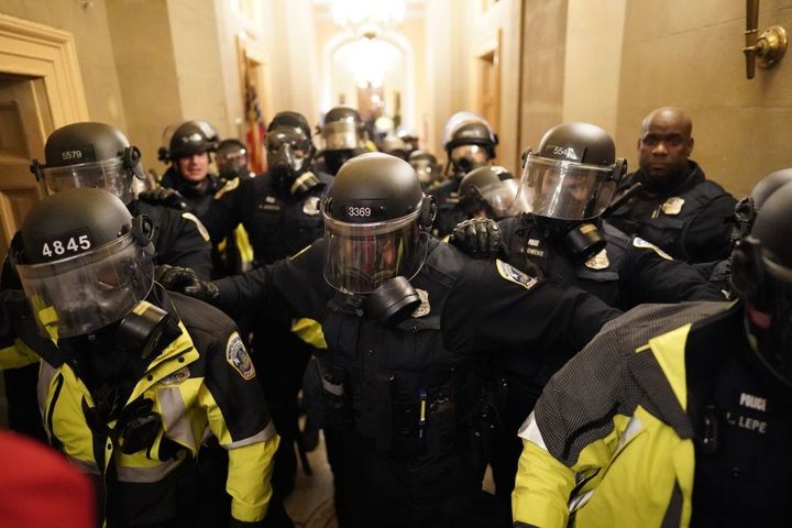 Riot police clear the hallway inside the Capitol on Jan. 6, 2021.