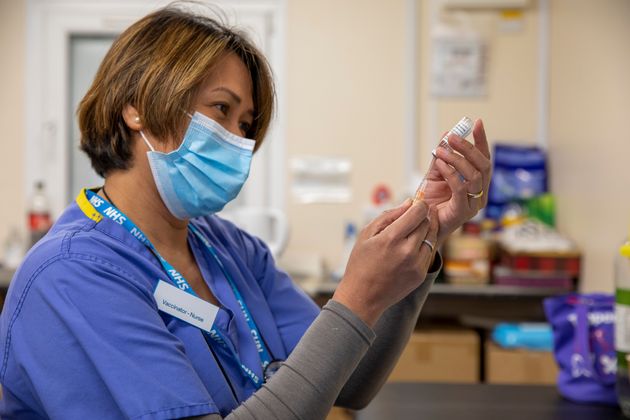 A vaccination nurse draws up a syringe of the AstraZeneca Covid-19 vaccination ready for patients arriving at the Folkestone drive through medical centre
