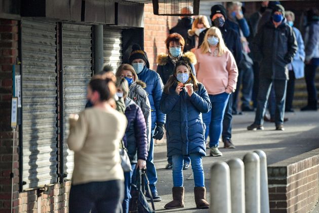 People wait in line for a coronavirus test at a surge test centre, set up in a library, to provide additional community testing following the identification of a mutated variant in the Bristol and south Gloucestershire area