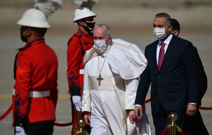 Pope Francis walks alongside Iraq's Prime Minister Mustafa al-Kadhem upon his arrival in Baghdad on March 5, 2021 on the first papal visit to Iraq.