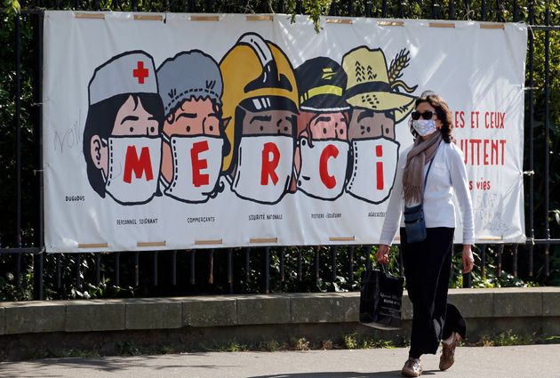 Une banderole de l'artiste Regis Leger alias Dugudus remerciant les soignants, les commerçants, la sécurité nationale, le personnel de la poste et les agriculteurs au moment du premier confinement, le 16 avril 2020 à Paris. (Photo by Chesnot/Getty Images)