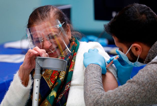 A woman receives the Oxford/AstraZeneca Covid-19 vaccine at the Al-Abbas Islamic Centre, which has been converted into a temporary vaccination centre in Birmingham.