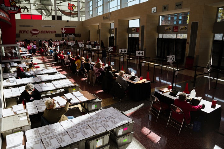 Election officials wait for voters in the KFC YUM! Center on Nov. 3 in Louisville. The 2020 election was the first time many 