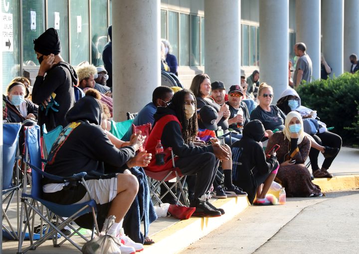Hundreds of unemployed Kentucky residents wait in long lines outside the Kentucky Career Center in Frankfort for help with their unemployment claims on June 19, 2020.