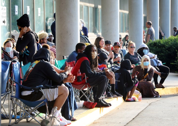 Hundreds of unemployed Kentucky residents wait in long lines outside the Kentucky Career Center in Frankfort for help with their unemployment claims on June 19, 2020.