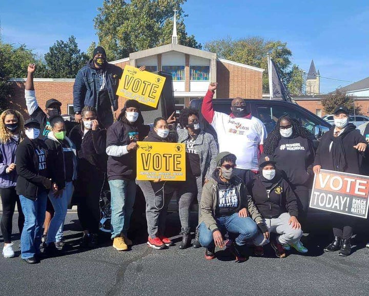 Savvy Shabazz (center, arm raised) is seen with members of the group All of Us or None Louisville during a voter registration