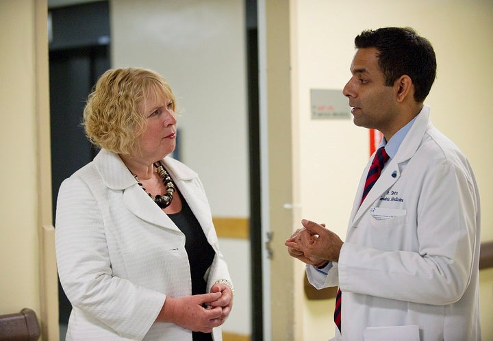 Dr. Samir Sinha speaks with the former minister of health in this 2012 photo.