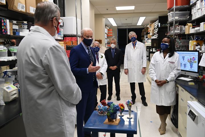 President Joe Biden tours the Viral Pathogenesis Laboratory at the National Institutes of Health on Feb. 11, flanked by Dr. Barney S. Graham, left, Dr. Anthony Fauci, White House COVID-19 coordinator Jeffrey Zients, NIH Director Francis Collins and Dr. Kizzmekia S. Corbett.