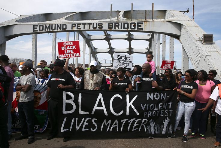 Thousands of people walk across the Edmund Pettus Bridge during the 50th anniversary on March 8, 2015, in Selma, Alabama. This year marks the 56th anniversary, and commemorations will be held remotely because of the coronavirus pandemic.