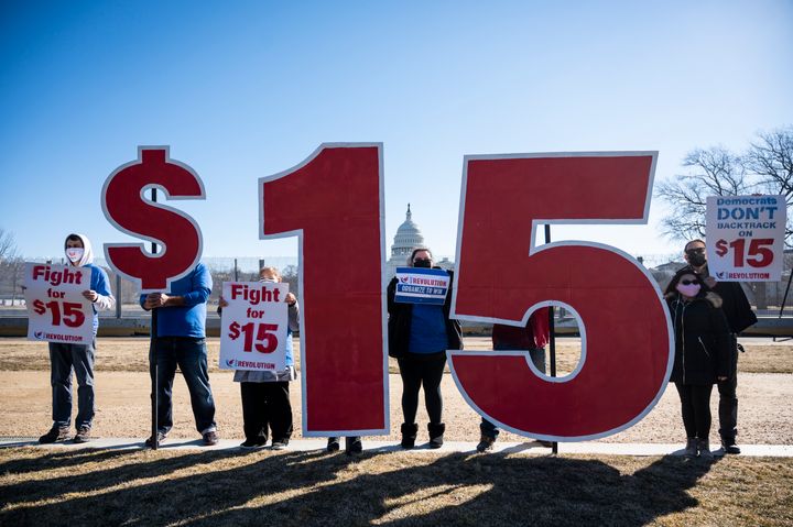 Activists with Our Revolution hold $15 minimum wage signs outside the Capitol complex on Thursday, Feb. 25, 2021, to call on Congress to pass the $15 federal minimum wage hike proposed as part of the COVID relief bill. 