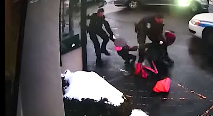 One officer can be seen tackling the woman while another tries to wrest away her 3-year-old daughter.