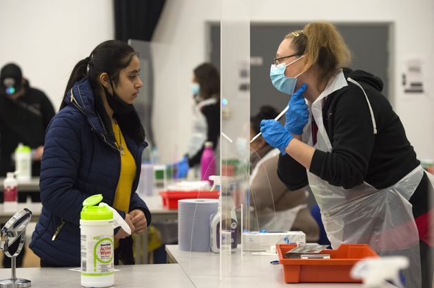 A student takes a Lateral Flow Test at Hounslow Kingsley Academy in West London, as pupils in England return to school for the first time in two months as part of the first stage of lockdown easing