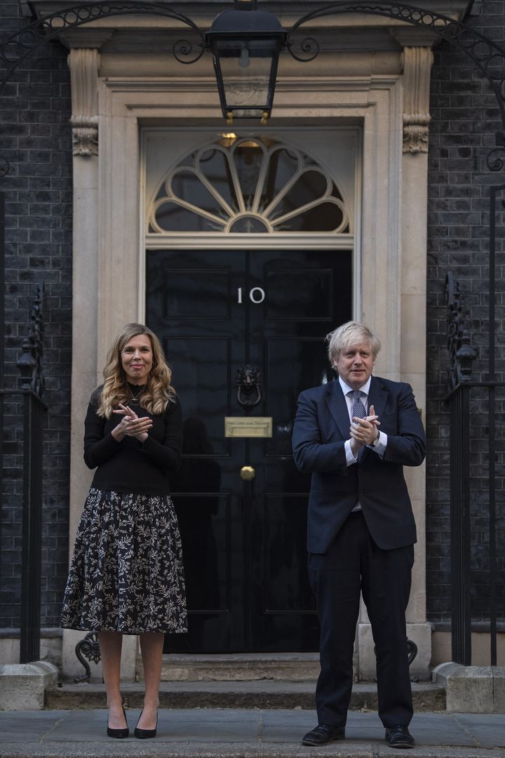 Boris Johnson and Carrie Symonds stand in Downing Street, London, to join in the applause to salute local heroes during the nationwide Clap for Carers to recognise and support NHS workers and carers fighting the coronavirus pandemic