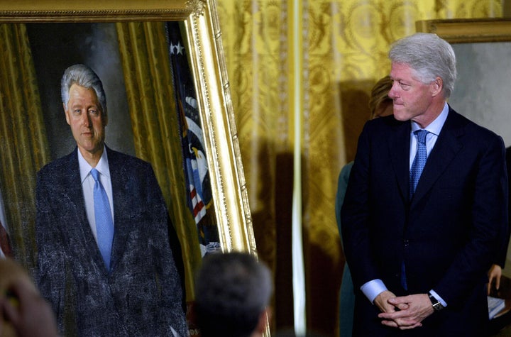 Former President Bill Clinton views his official White House portrait before it was hung in the grand foyer during the unveiling event hosted by President George W. Bush in 2004.