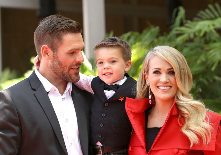Carrie Underwood with her husband, Mike Fisher, and their son Isaiah attend the ceremony honoring Underwood with a star on the Hollywood Walk of Fame in 2018 in Hollywood.