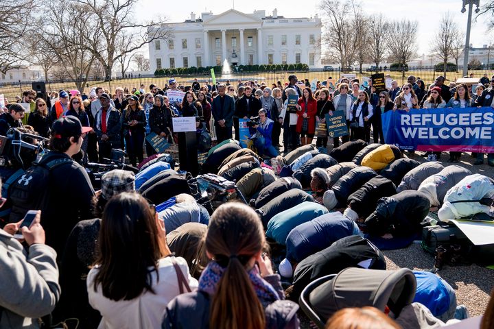 In this Jan. 27, 2018, file photo, a group holds the Islamic midday prayer outside the White House during a rally on the one-year anniversary of the Trump administration's first travel ban on citizens from seven Muslim-majority countries.