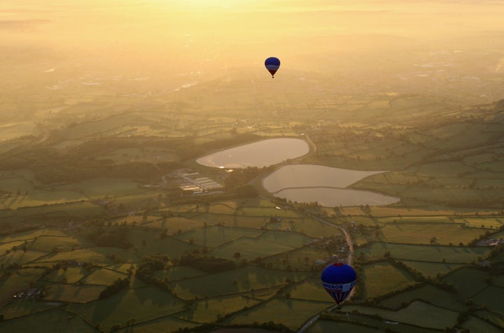 Balloons take off from the runway of Bristol International Airport as part of the Bristol International Balloon Fiesta.