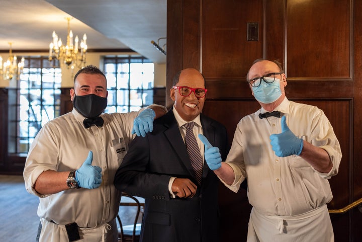 Two waiters get their photo taken with a wax figure of Al Roker at Peter Luger's Steakhouse in Brooklyn in New York City on M