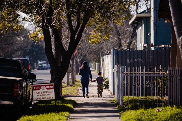 A mother and son walk through one of the neighborhoods of Stockton, California on Feb. 7, 2020. The city recently finished a two year basic income trial. 