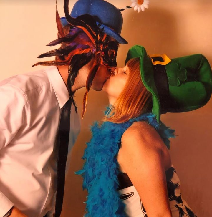 The author and her husband, seen in someone else's wedding photo booth. Inexplicably, the author thought a leprechaun hat was the perfect accessory.