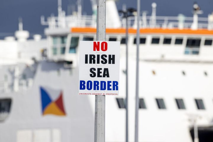 sign on a lamp post outside Larne Port with the word 'No Irish Sea Border'