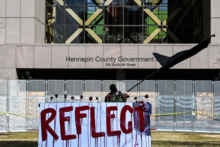 A demonstrator waves a black flag as he protests outside the Hennepin County Government Center as jury selection begins at the trial of former Minneapolis Police officer Derek Chauvin on March 8, 2021 in Minneapolis, Minnesota. (Photo by CHANDAN KHANNA / AFP) (Photo by CHANDAN KHANNA/AFP via Getty Images)