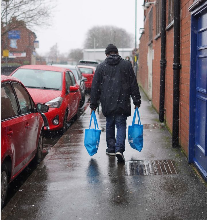 A man carrying food parcels to help those in need