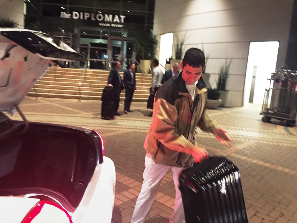 Julio Lopez handles a suitcase at the Diplomat Beach Resort in Hollywood, Florida, before COVID-19 forced it to close. The 16