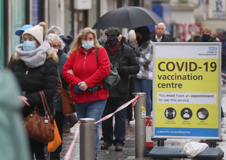 People queue to enter a Covid-19 vaccination centre in Folkestone, Kent.