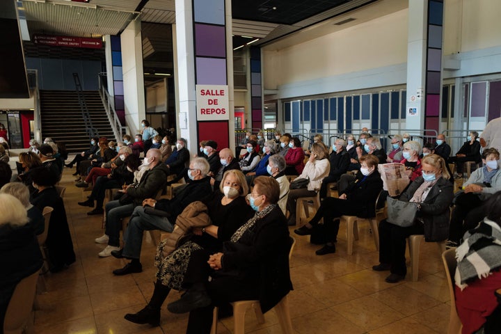 People wait in the "Salle de repos" for their turn to be vaccinated at a Covid-19 vaccination centre in the French riviera city of Nice, southern France.