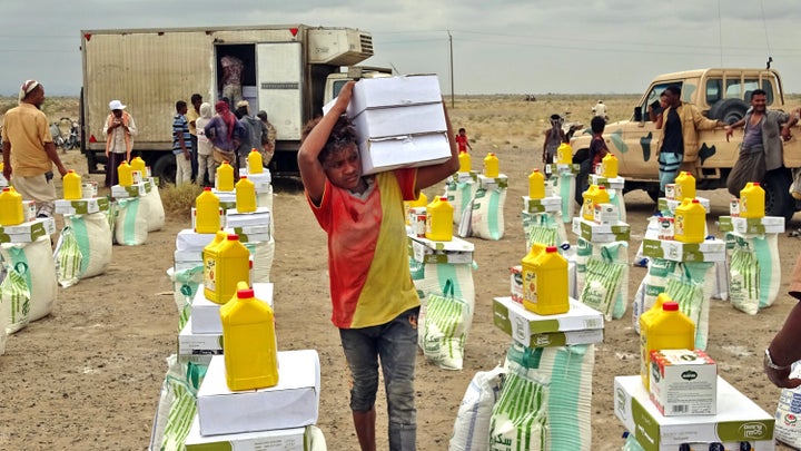 People displaced by conflict receive food donated by a Kuwaiti charity organization in the village of Hays, near the conflict zone in Yemen's western province of Hodeida, on Feb. 22.