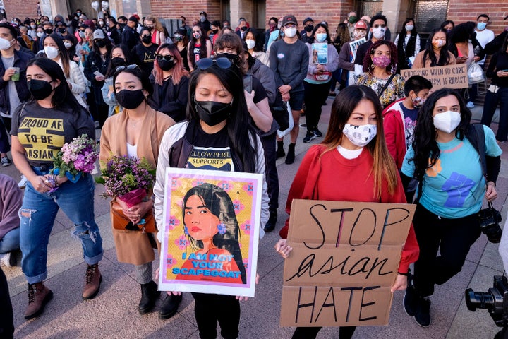 Demonstrators wearing face masks and holding signs take part in a rally "Love Our Communities: Build Collective Power" to raise awareness of anti-Asian violence, at the Japanese American National Museum in Little Tokyo in Los Angeles, California, on March 13.