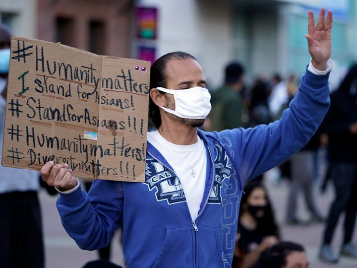 In this March 13, 2021, file photo, a man participates in the rally "Love Our Communities: Build Collective Power" to raise awareness of anti-Asian violence outside the Japanese American National Museum in Little Tokyo in Los Angeles. (AP Photo/Damian Dovarganes, File)