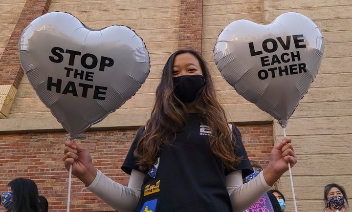 In this March 13, 2021, file photo, Chinese-Japanese American student Kara Chu, 18, holds a pair of heart balloons decorated 