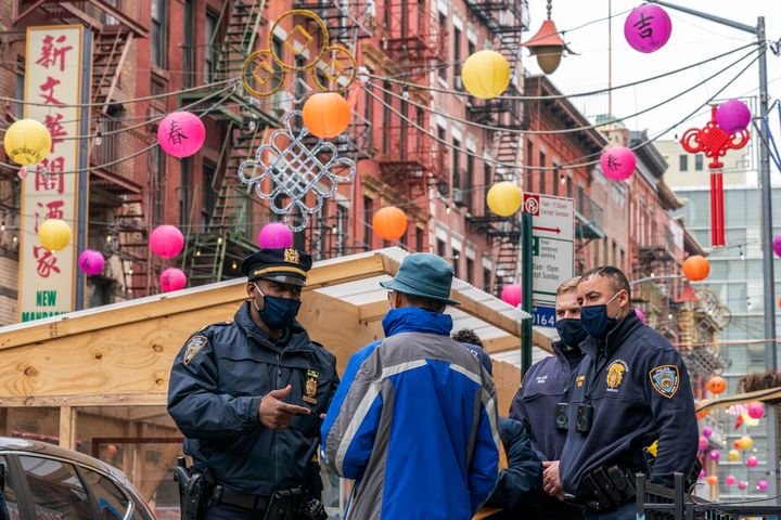 In this March 17, 2021, file photo, Capt. Tarik Sheppard, left, Commander of the New York Police Department Community Affairs Rapid Response Unit speaks to a resident while on a community outreach patrol in the Chinatown neighborhood of New York. (AP Photo/Mary Altaffer, File)