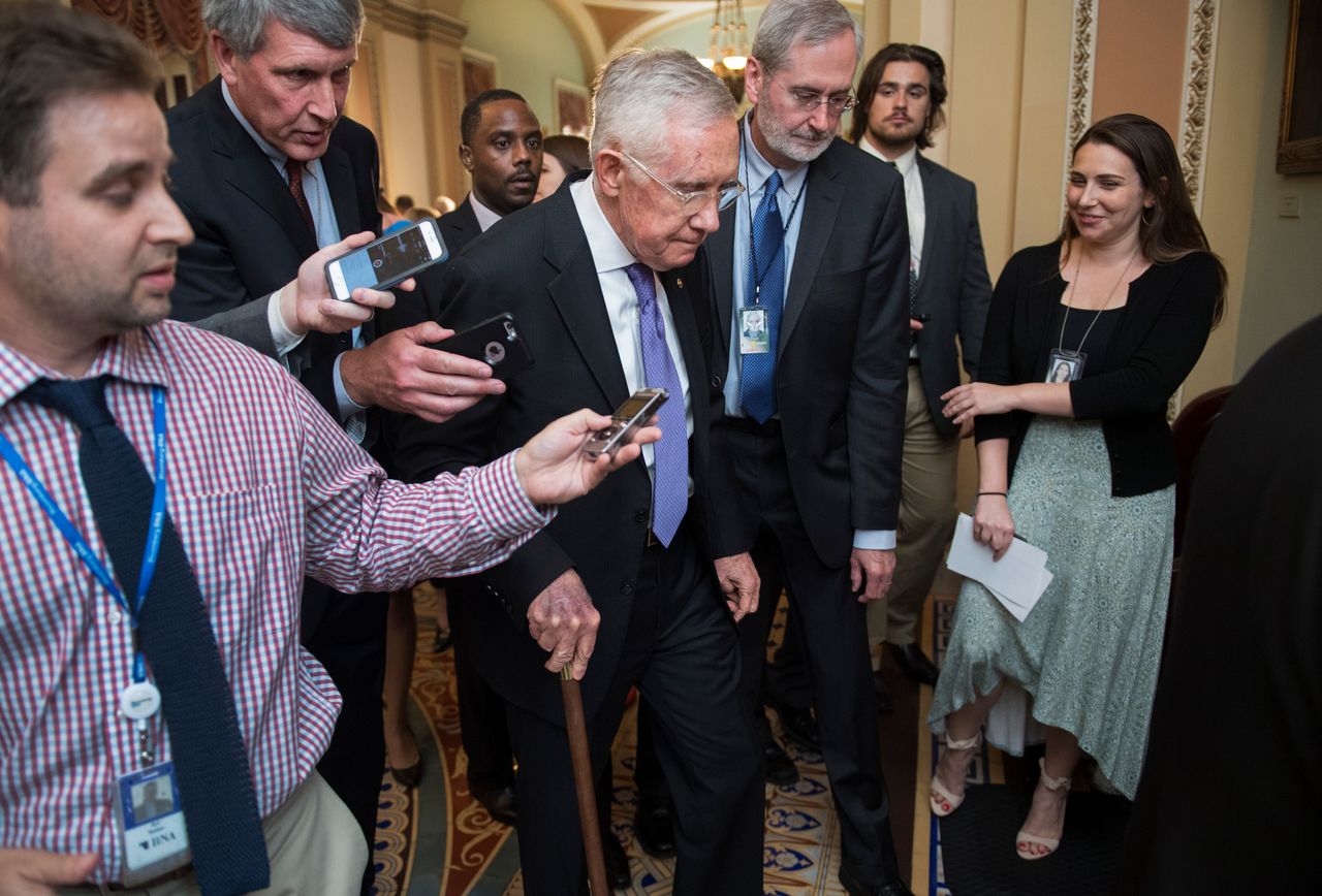 Dauster (center right) was deputy chief of staff to Senate Democratic leader Harry Reid (center) for six years and worked for a number of other senators over the years.