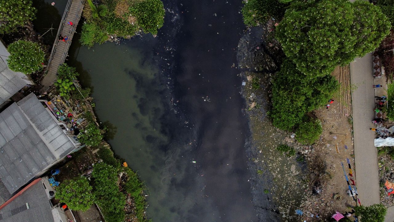 Ανθρωποι ψαρεύουν στον ποταμό Πισάνγκ Μπατού, ο οποίος περνάει μέσα από πυκνοκατοικημένη περιοχή στο Μπεκάσι, στα περίχωρα της Τζακάρτα, στην Ινδονησία. Είναι μολυσμένος με σκουπίδια κάθε είδους και παρά τις πολλές προσπάθειες καθαρισμού, τα νερά του είναι μαύρα και βρωμάνε έντονα.