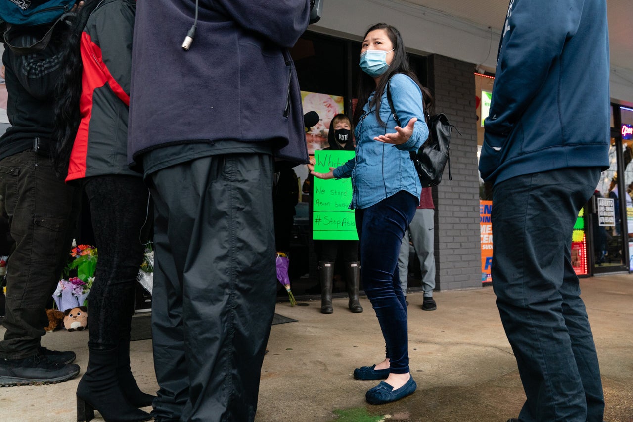 Lijing Zhao, owner of Jo Jos Massage, speaks to the media on March 17, 2021, after laying a bouquet of flowers outside the spa where four people were shot and killed in Acworth, Georgia.
