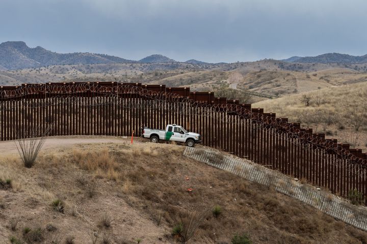 A Border Patrol officer sits inside his car at the U.S.-Mexico border fence, in Nogales, Arizona, on February 9, 2019.