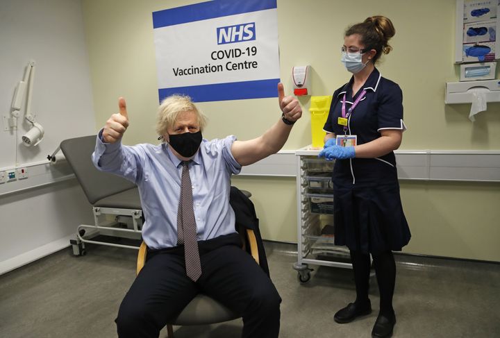 Boris Johnson gives thumbs up after receiving the first dose of AstraZeneca vaccine administered by nurse Lily Harrington.