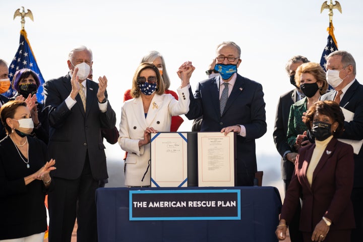 Speaker of the House Nancy Pelosi (D-Calif.) and Senate Majority Leader Chuck Schumer (D-N.Y.), center, sign H.R. 1319 American Rescue Plan Act during a bill enrollment ceremony on Capitol Hill, March 10.