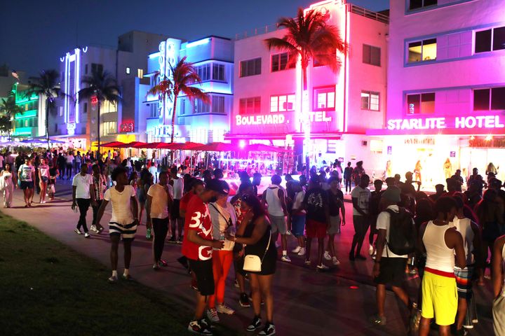 People gather along Ocean Drive on March 18 in Miami Beach, Florida. City officials are concerned with large spring break crowds as the coronavirus pandemic continues.