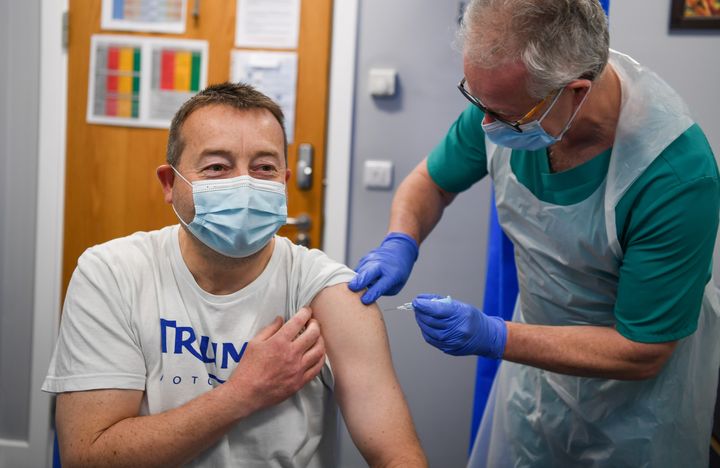 Vaccinators administer the Oxford AstraZeneca Covid vaccine at the medical centre on March 20, 2021 in Bridport, England. 
