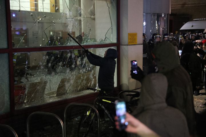 Protester smashes a Bridewell Police Station window as they take part in a 'Kill the Bill' protest in Bristol.