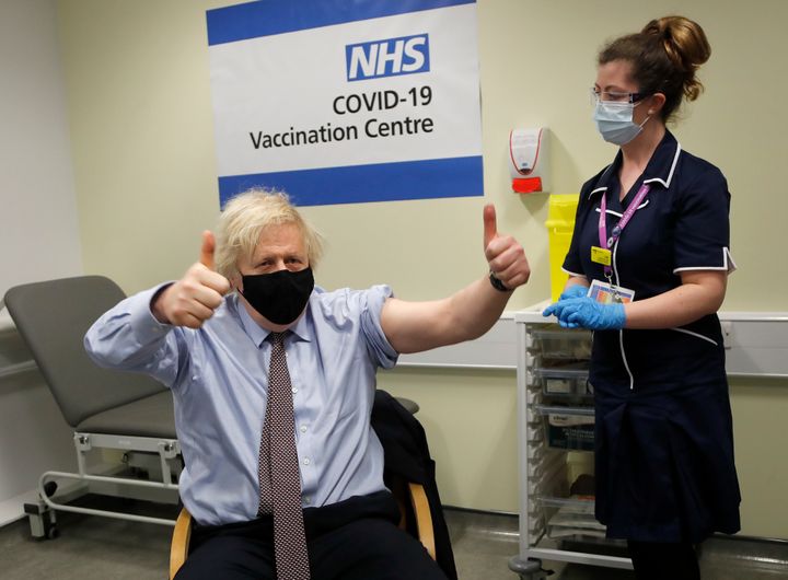 Boris Johnson gestures after receiving the first dose of AstraZeneca vaccine l on March 19.
