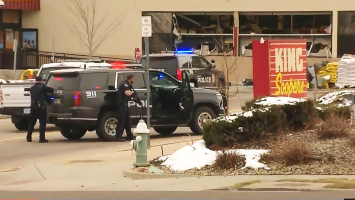 Police take positions outside the King Soopers grocery store in Boulder, Colorado, on Monday after reports of an active shoot