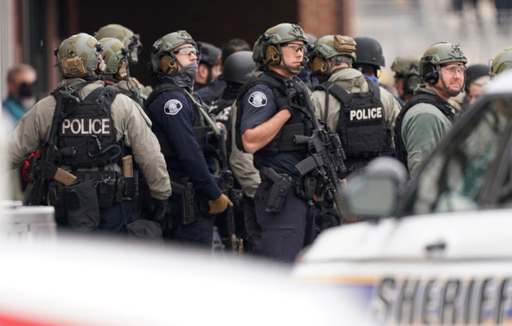 Police in tactical gear gather at the King Soopers grocery store in Boulder.